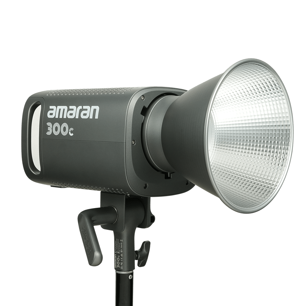 Side view of Amaran 300c LED CoB light with Bowens Mount Hyper reflector attached on a transparent background.