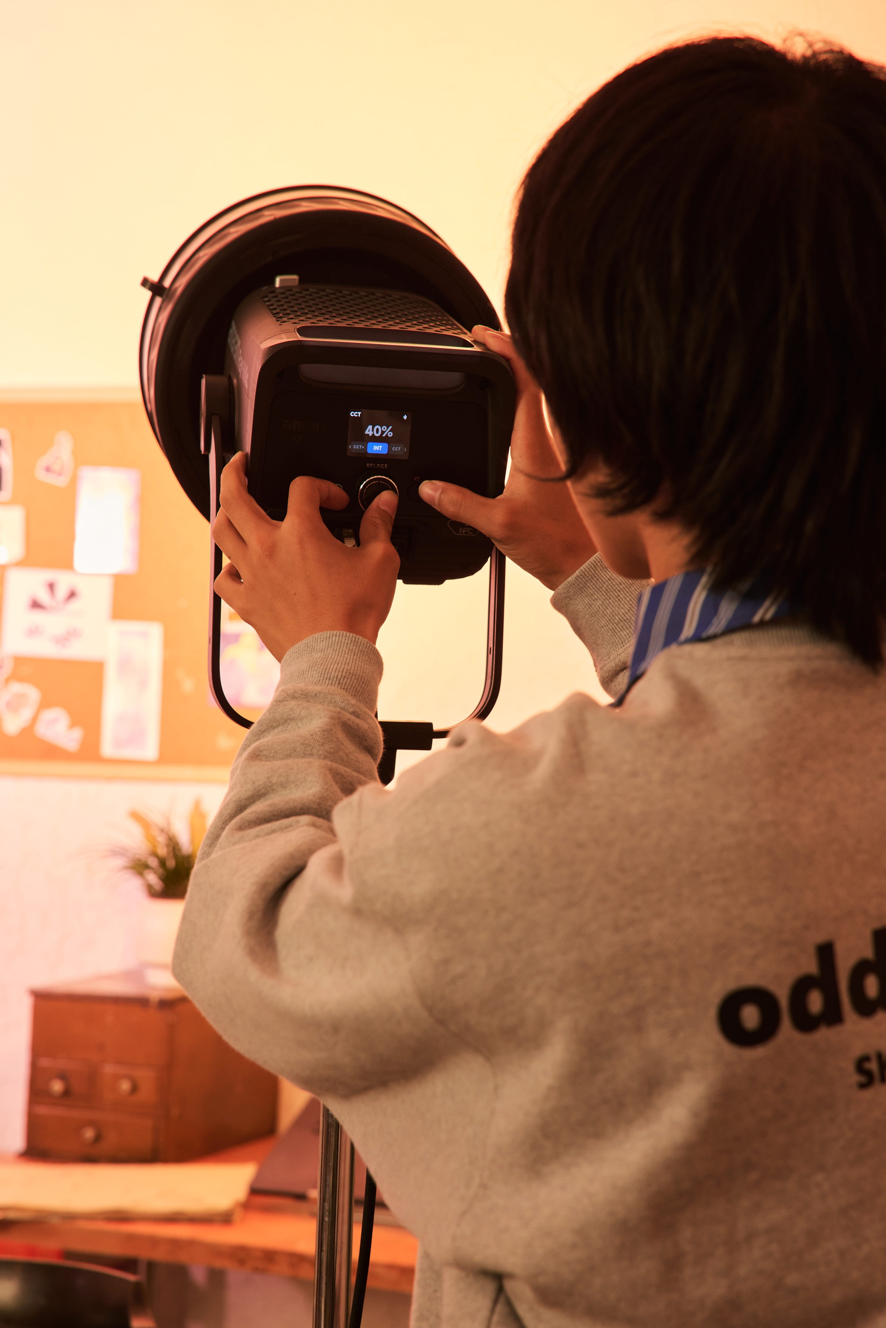 amaran light with fresnel being monitored by technician.