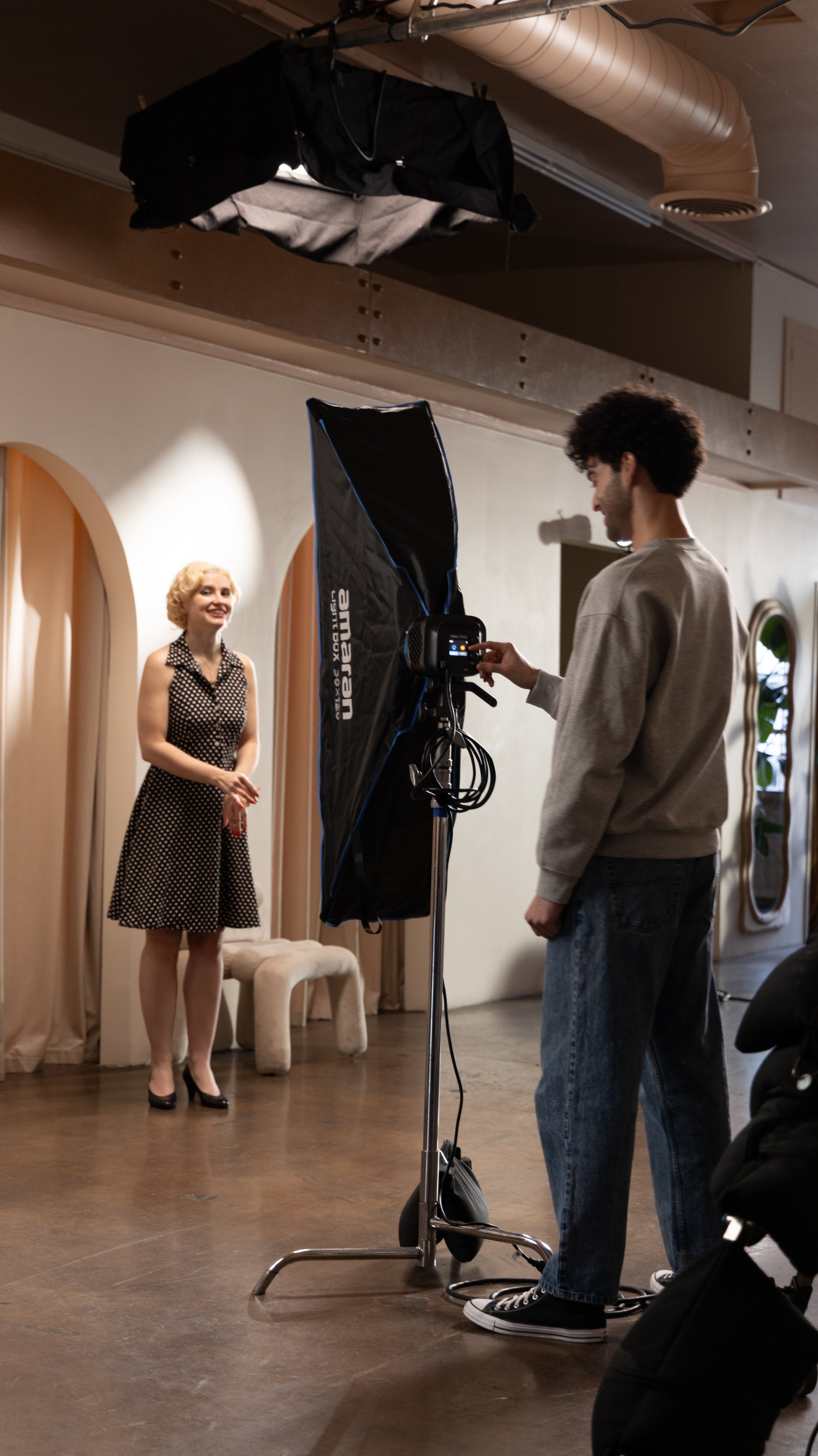 amaran Halo 200x with light shaper connected in a studio with a female model.