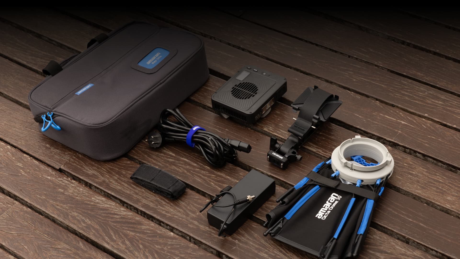 Amaran Ray 120 or Ray 60 kit, flat lay on a wooden background. 