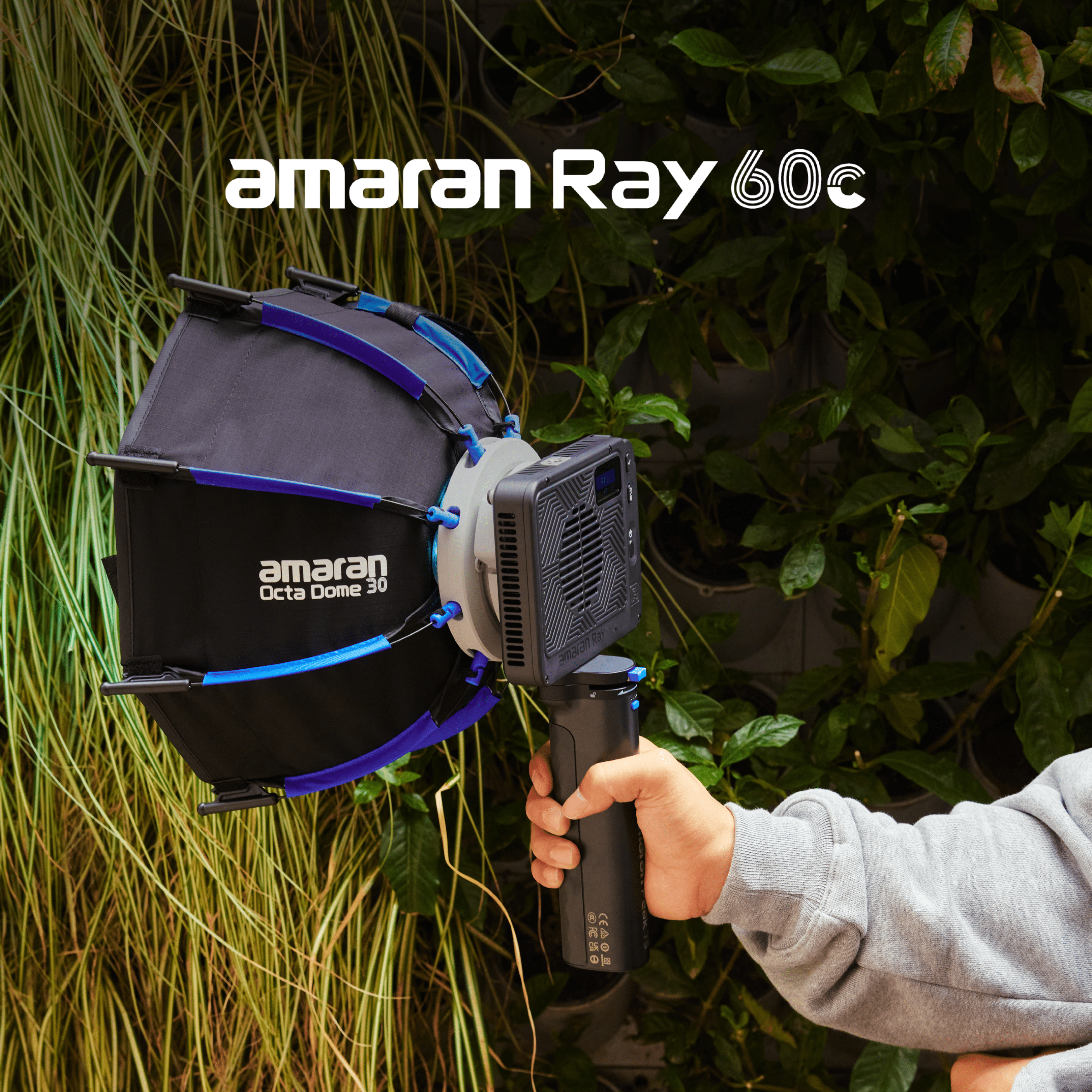 A person controlling an amaran Ray 60c with the grip and Octa Dome 30.