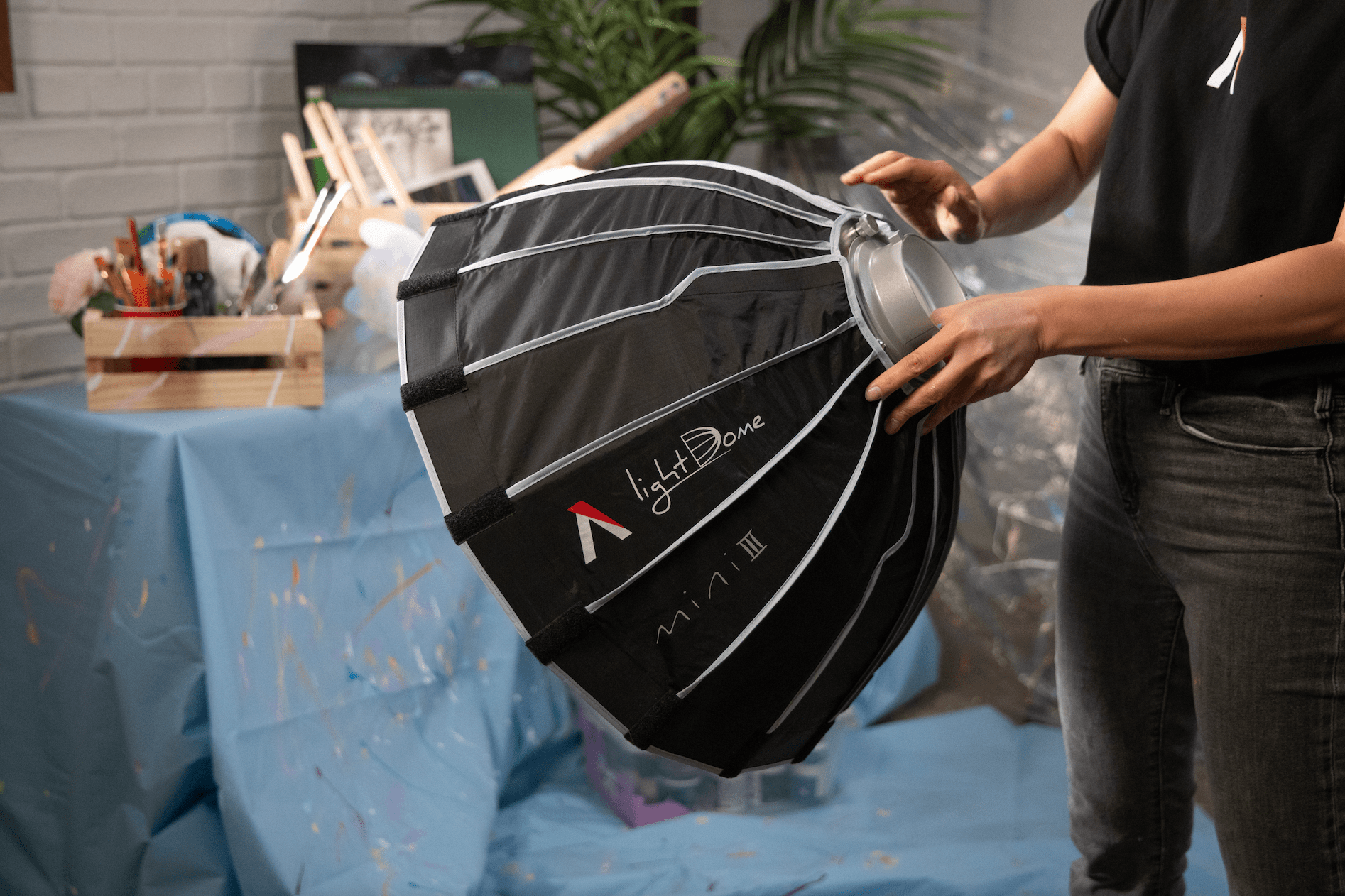 Lighting Operator adjusting the Aputure Light Dome Mini III.