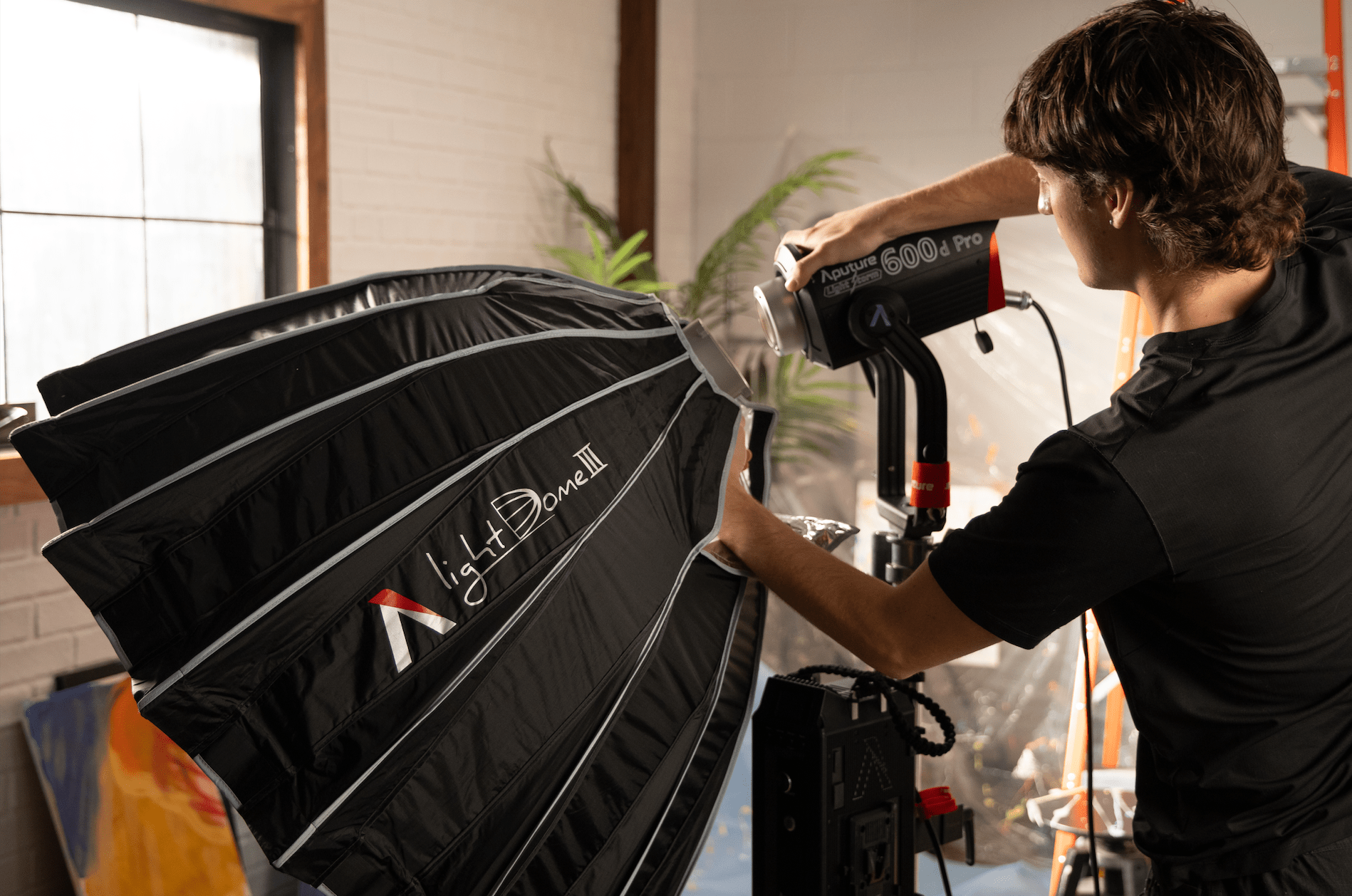 Lighting operator connecting Aputure Light Dome III to Aputure 600d pro.