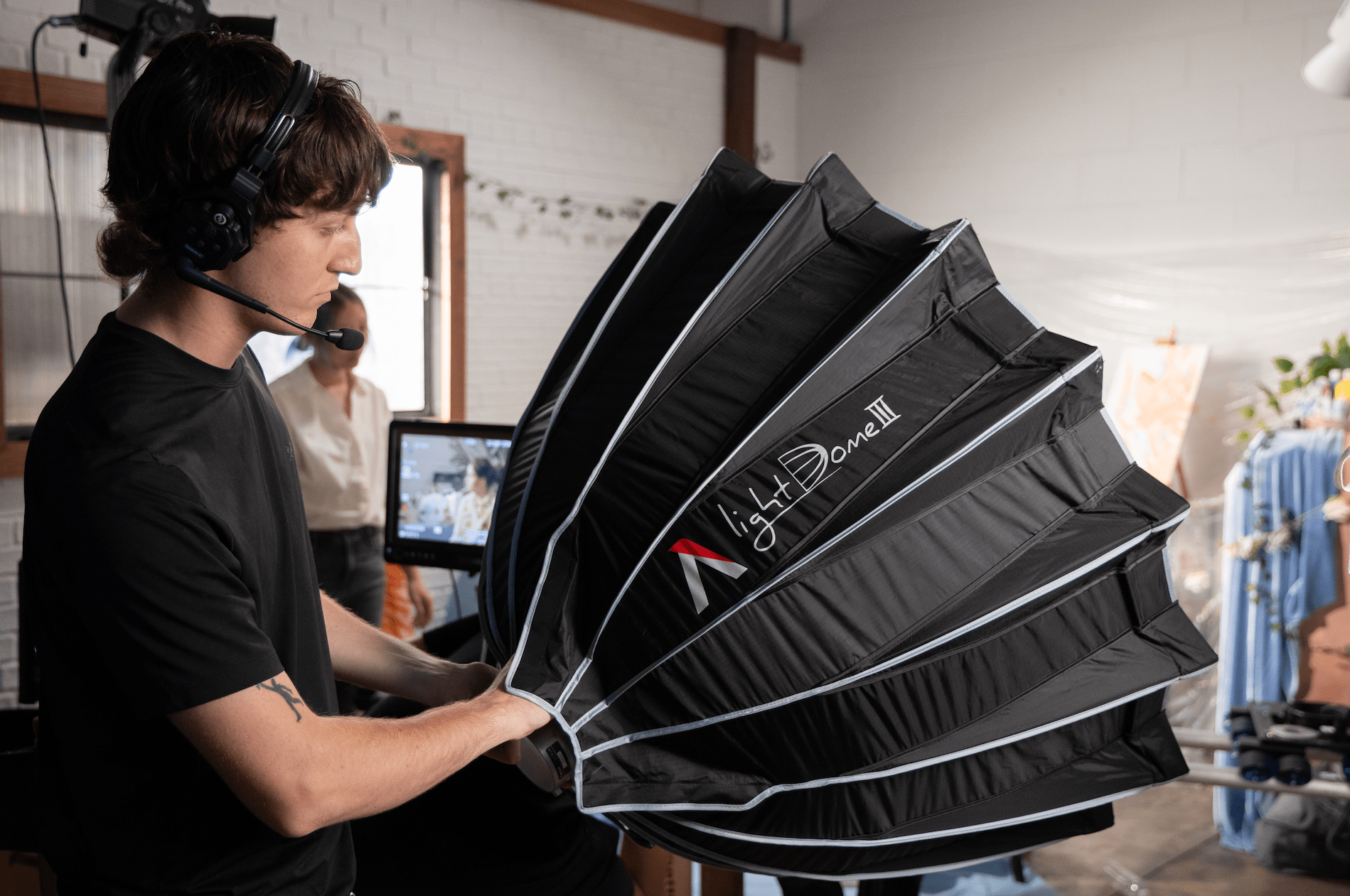 Lighting Operator controlling Aputure Light Dome MKIII in a studio.