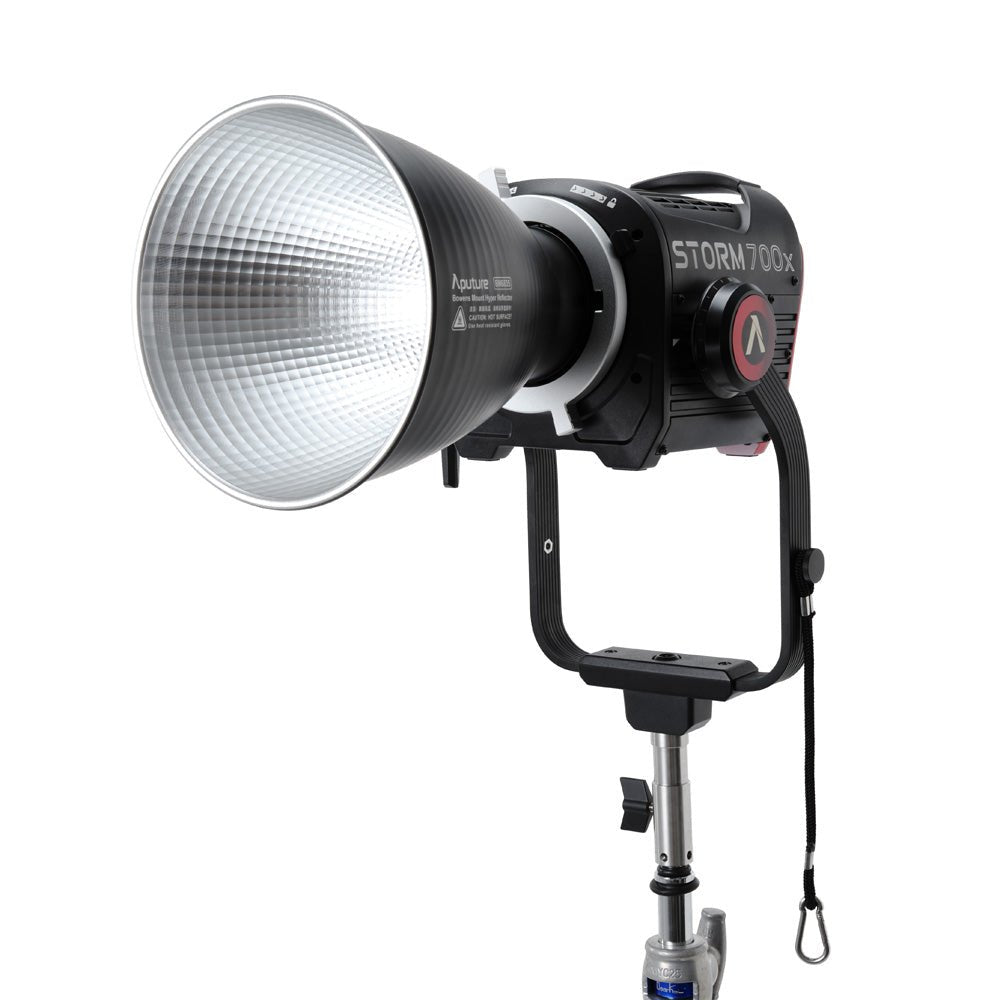 Aputure Storm 700x on a light stand with a reflector attached.