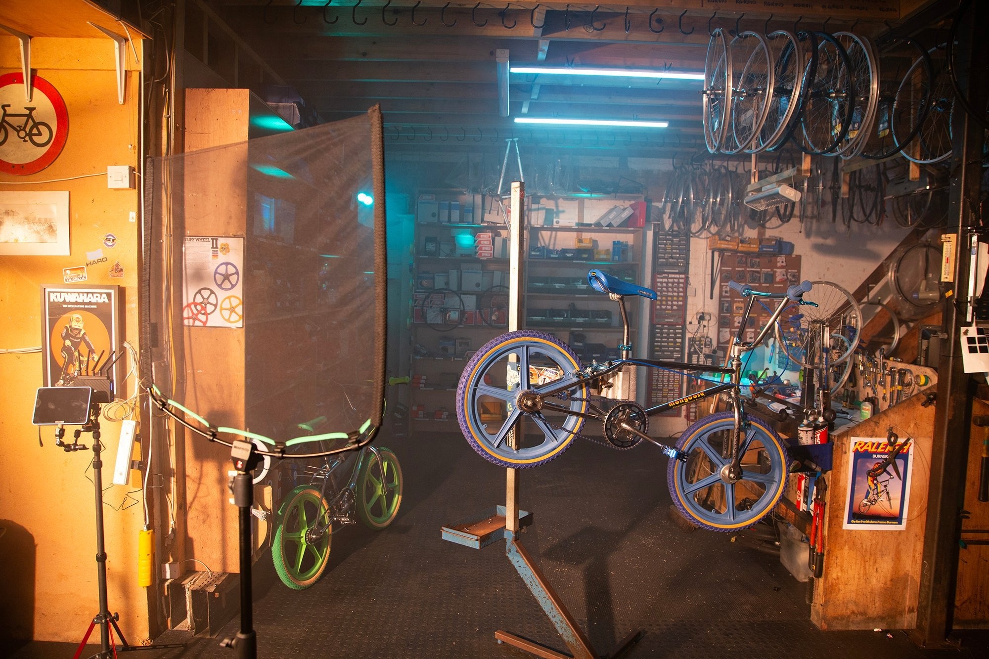 Inside a bike repair shop, showing the Rapid Flag frame and Single Scrim in the foreground.