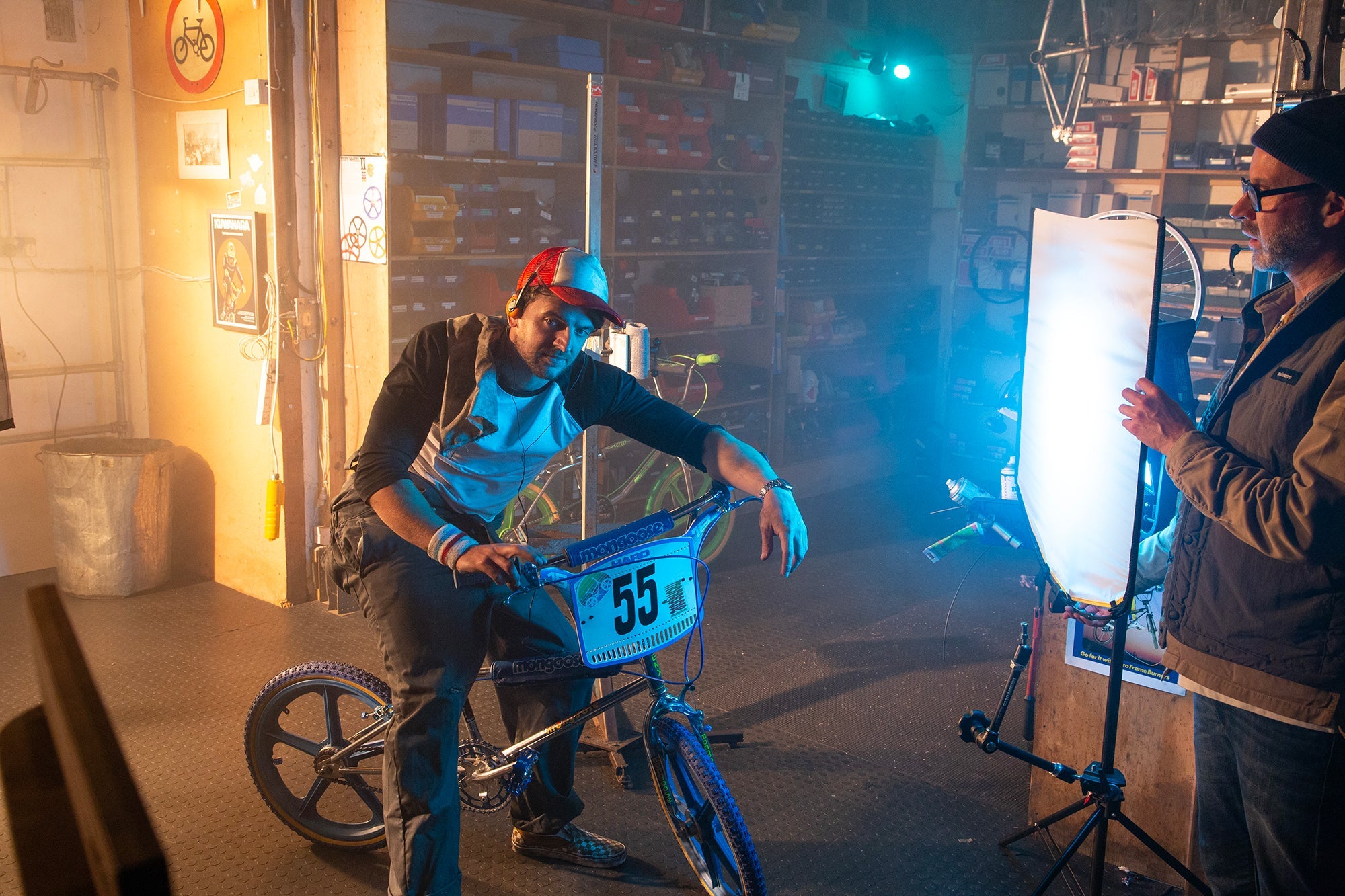 A film set showing an assembled Manfrotto Rapid Collapsible Rapid Frame shown with Artificial Silk illuminating a BMX with rider and lighting technician rigging the set in the foreground.