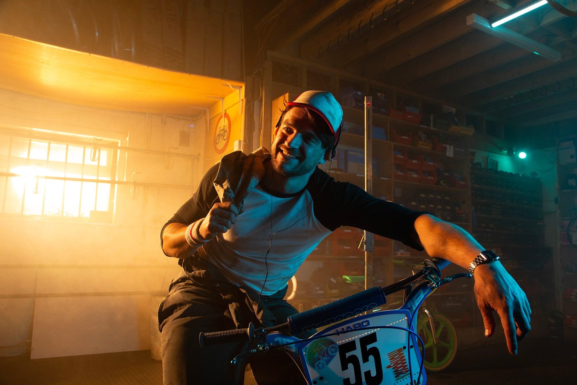 Rider on a BMX in a bke repair shop.