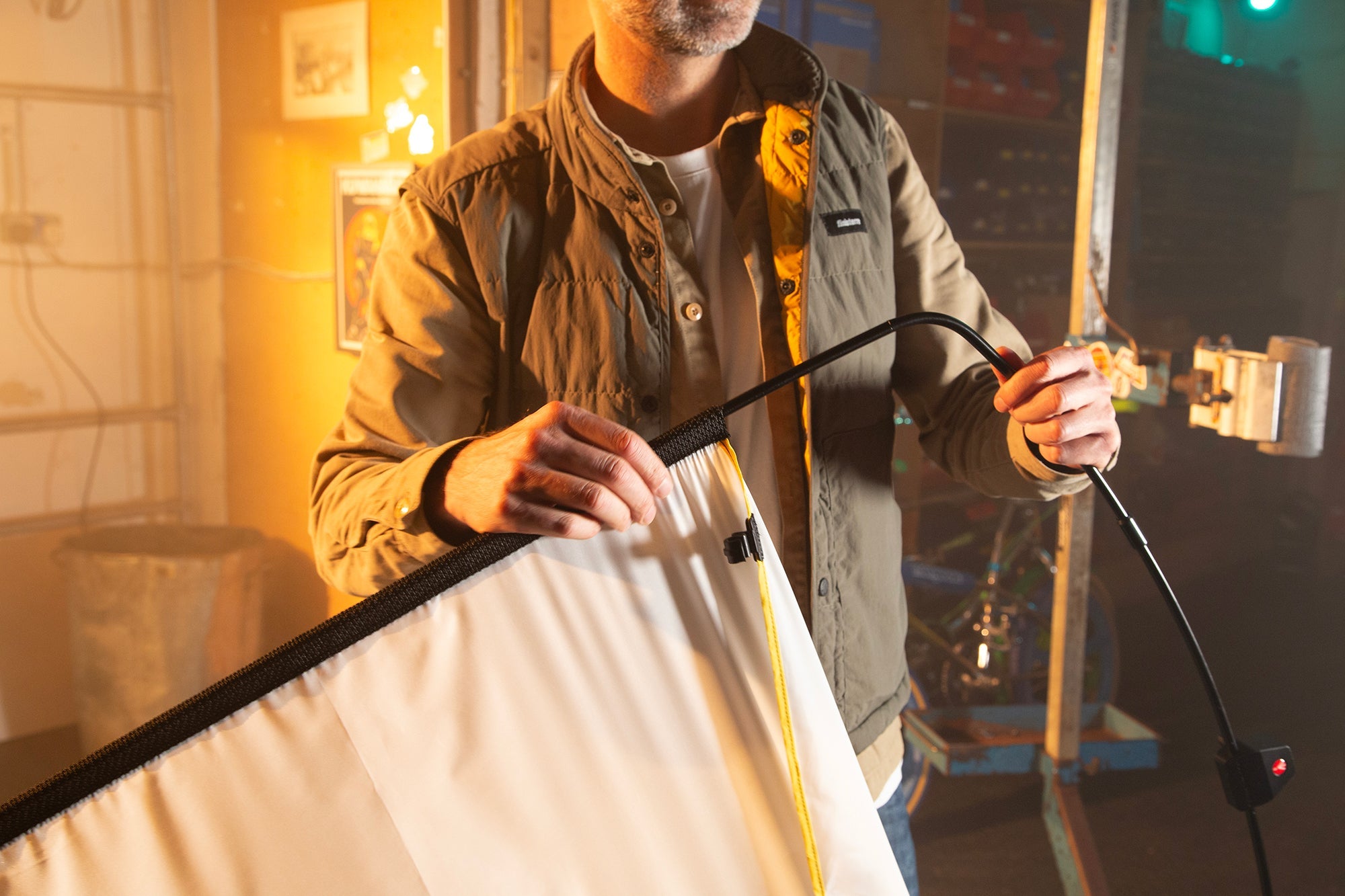 A lighting technician assembling the LL LR1912 Rapd Flag kit with Silk being placed onto the metal frame. 