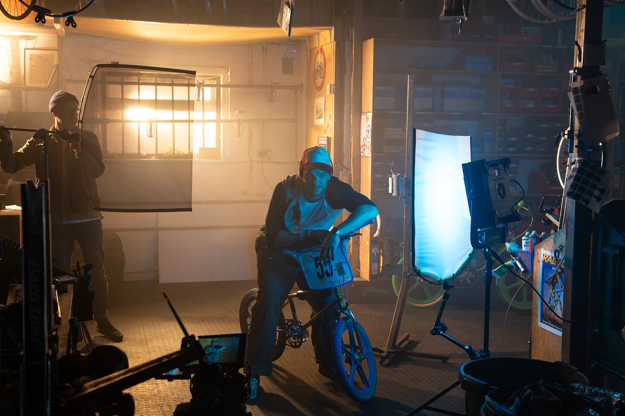 A film set showing an assembled Manfrotto Rapid Collapsible Rapid Frame shown with Artificial Silk illuminating a BMX with rider and lighting gaffer rigging the set in the background.