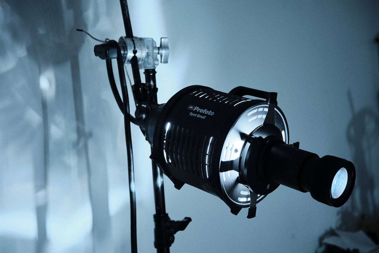 Profoto Spot Small on a C-Stand against a duckegg blue background.