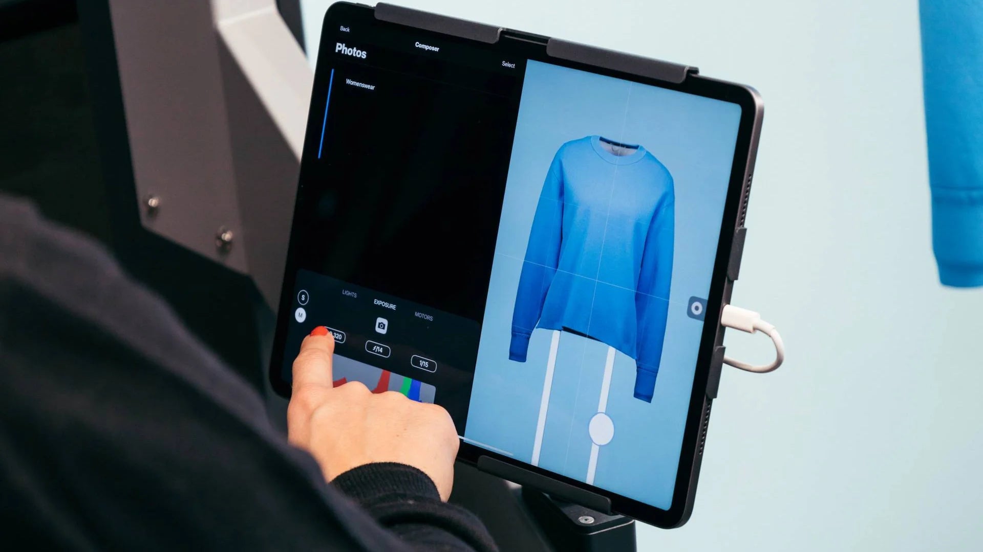 A person controlling the light via the iPad for the Profoto Elevate.
