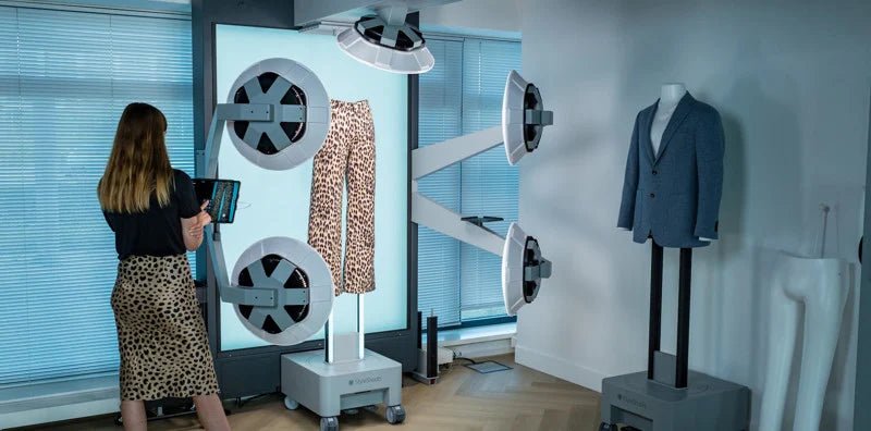 A woman controlling the iPad for the Profoto StyleShoots Vertical with leopard print trousers being photographed using the device.