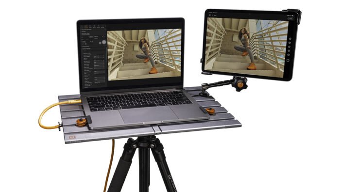 Workstation with laptop and tablet being connected by Tether Tools AeroTrac 1/4"-20 Accessory Threads (set of 3).