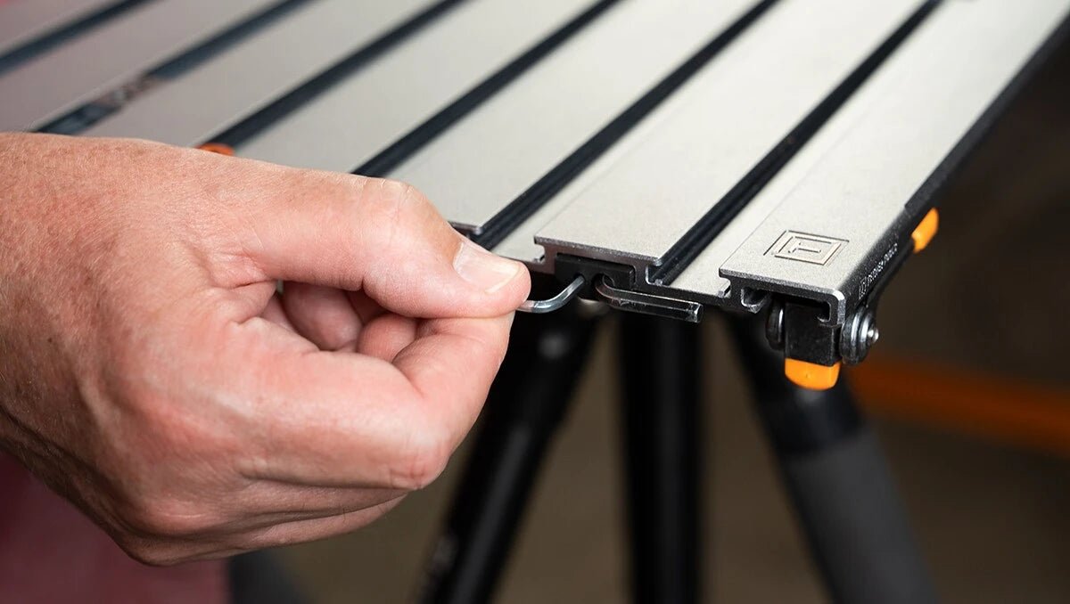 Person adjusting a tool on a Tether Tools AeroTrac Configuration Tool.