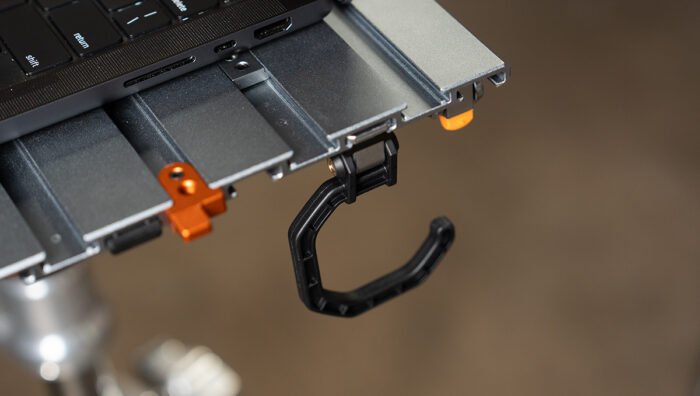 Close-up of Tether Tools AeroTrac Hooks (set of 2) attached to a workstation.