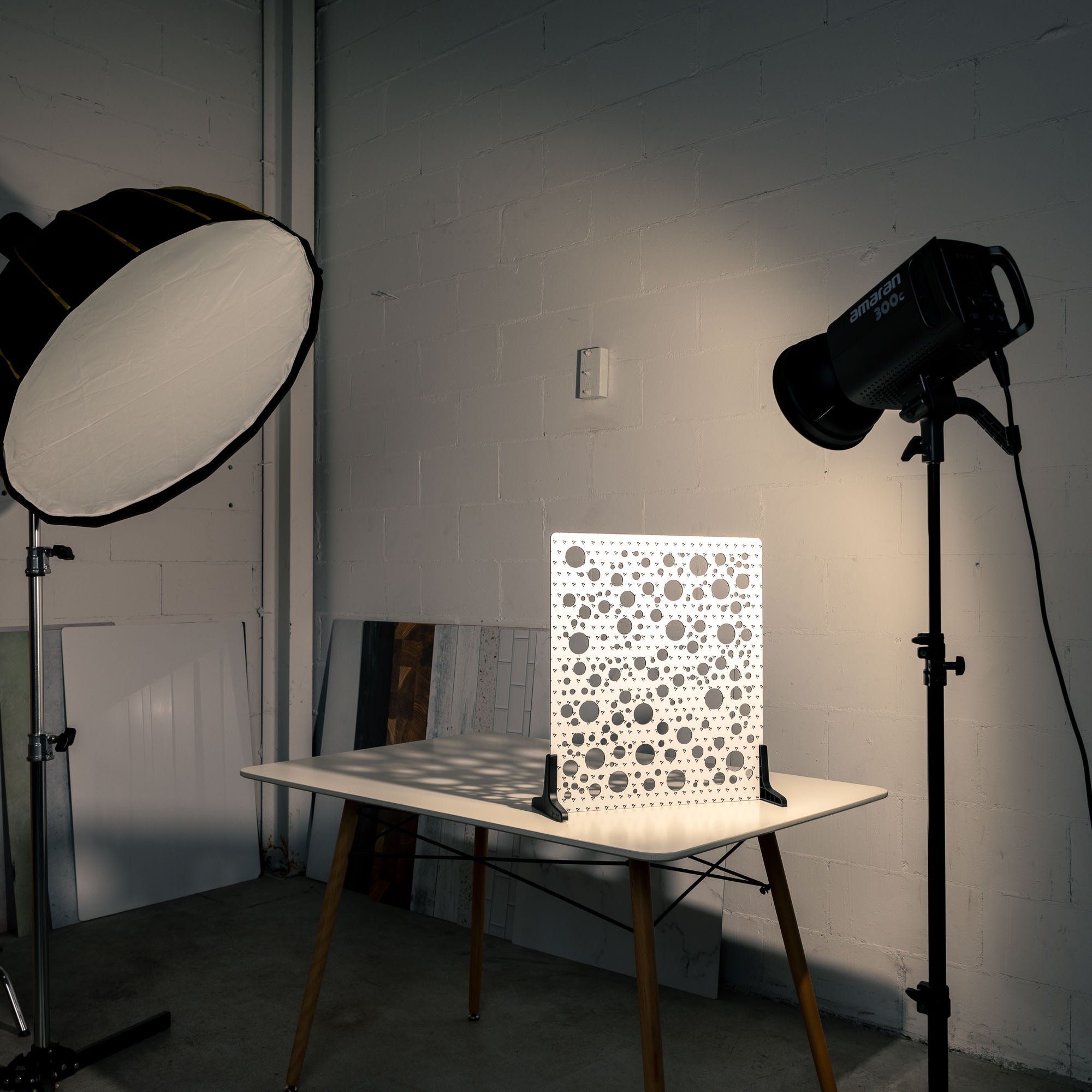 V-Flat 'Circles' Shadow Board BTS image with spotlight projecting light through the shaper.