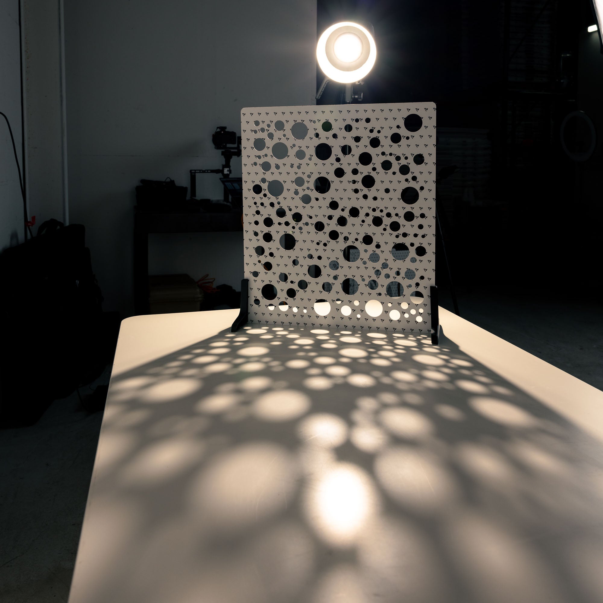 V-Flat 'Circles' Shadow Board with a spotlight projecting through the light shaper.