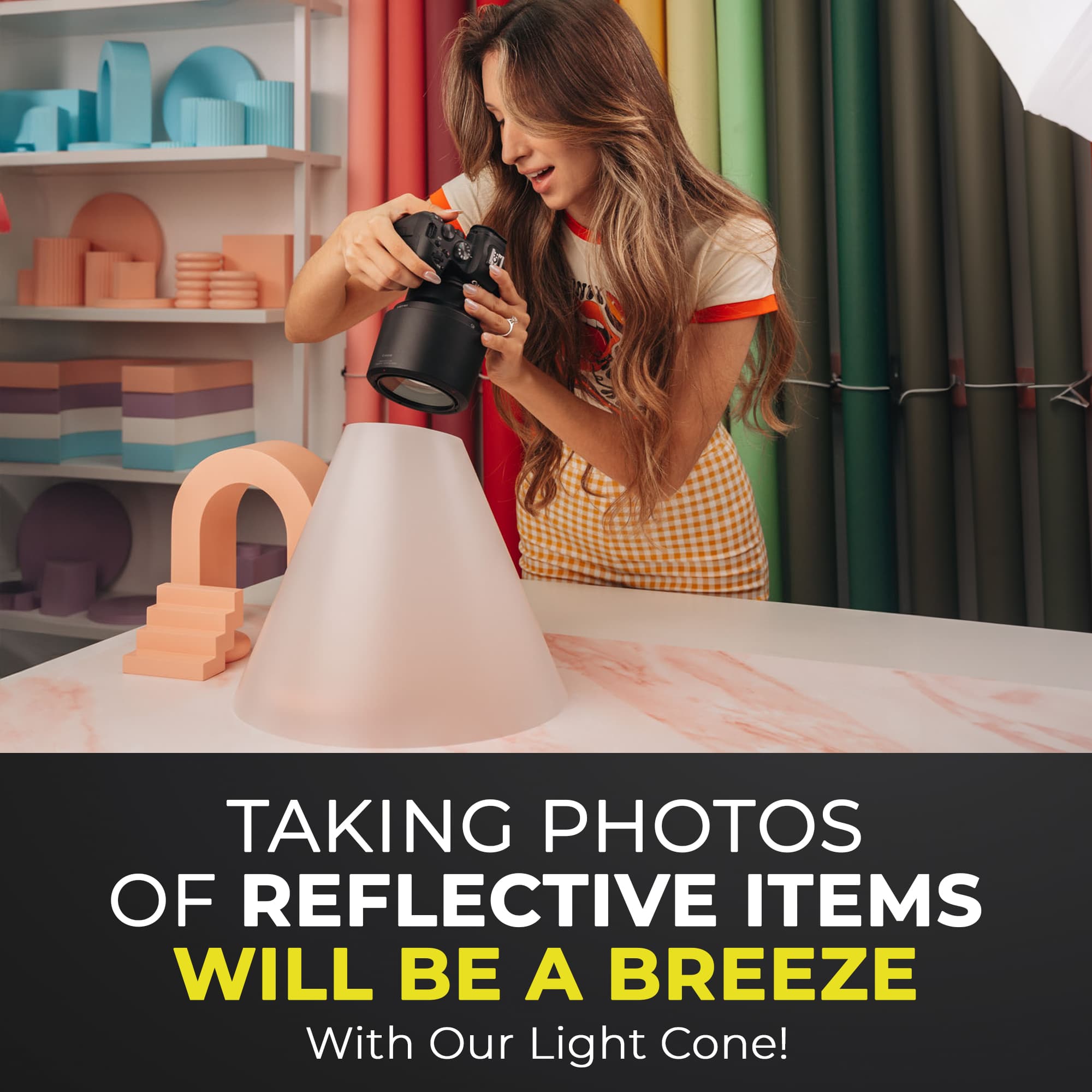 A person photographing a product using the V-Flat Light Cone - Medium.