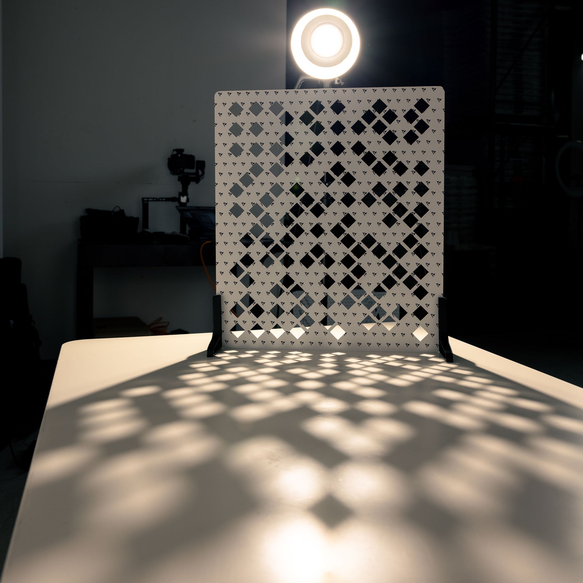 V-Flat 'Scattered Diamonds' Shadow Board with spotlight projecting light through the shaper.