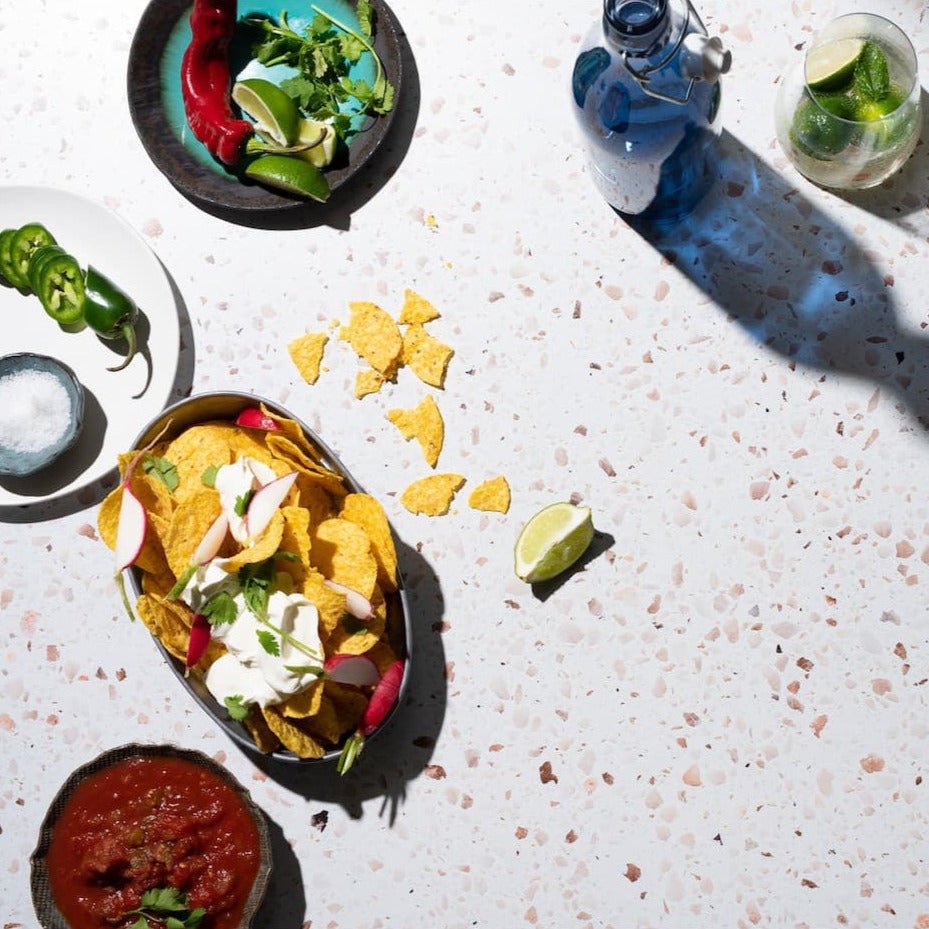 A selection of Mexican food being photographed on a V-Flat Terrazzo A/B - XL Duo Board.