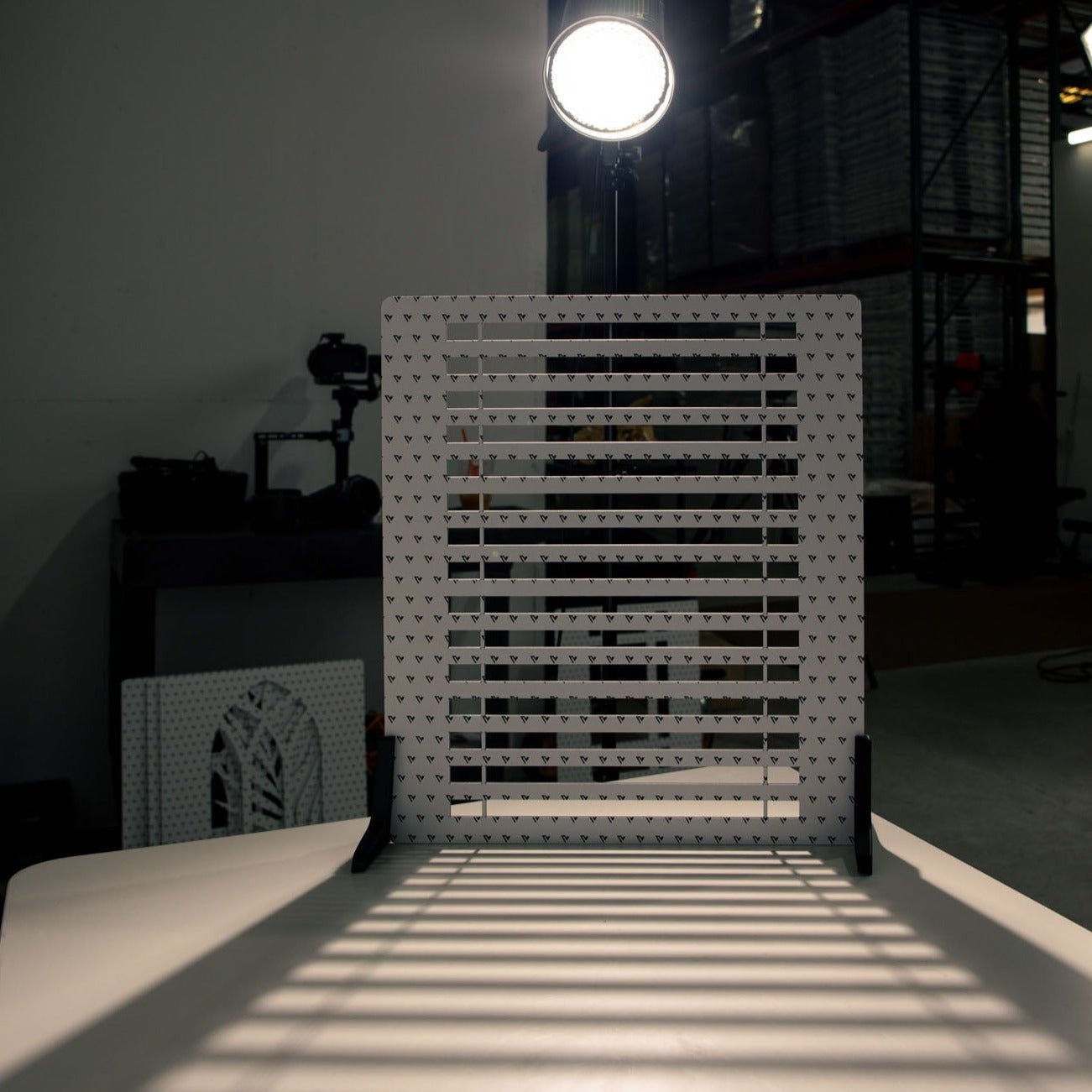 V-Flat Window Blinds with a light in the background.