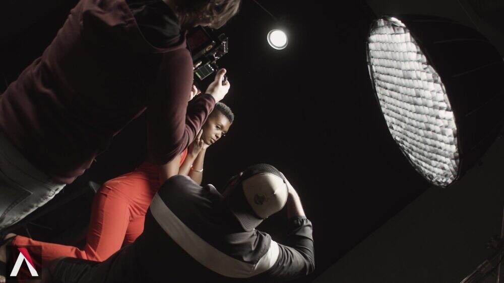 A studio shoot using an Aputure softbox with a model and two photographers.