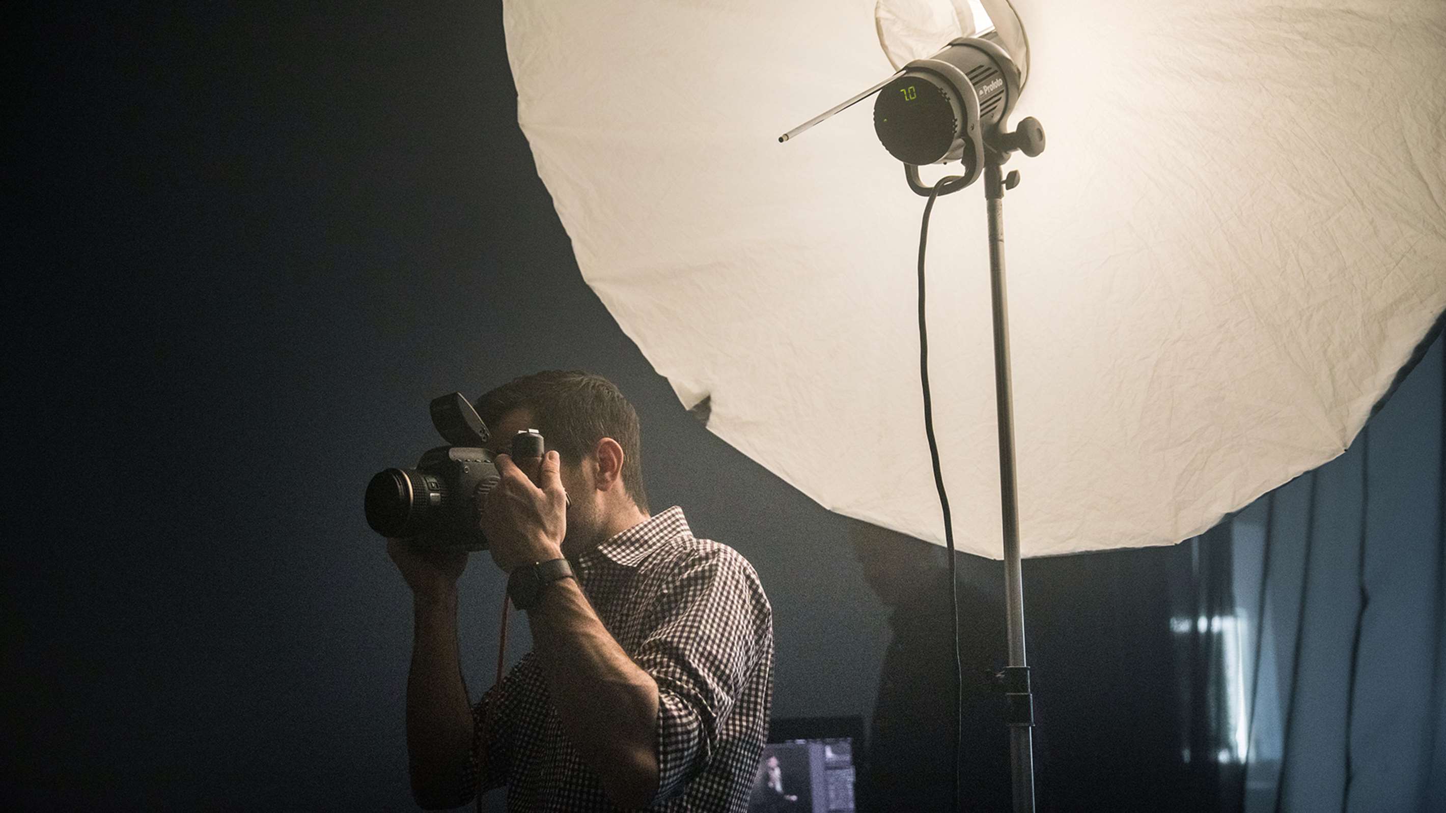 Umbrella with a diffuser being used on a location shoot